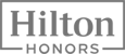 The image shows the "Hilton Honors" logo, which is the loyalty program for Hilton Hotels. It features the words in a bold, uppercase font.