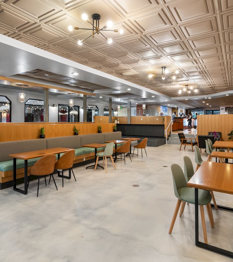 a wide view of a modern dining area with booths and tables