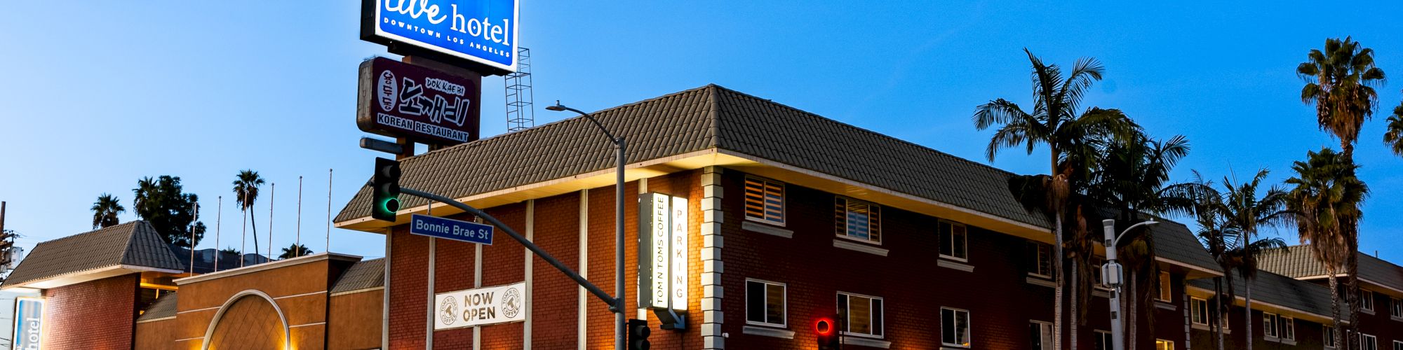 A street corner with a hotel sign reading 