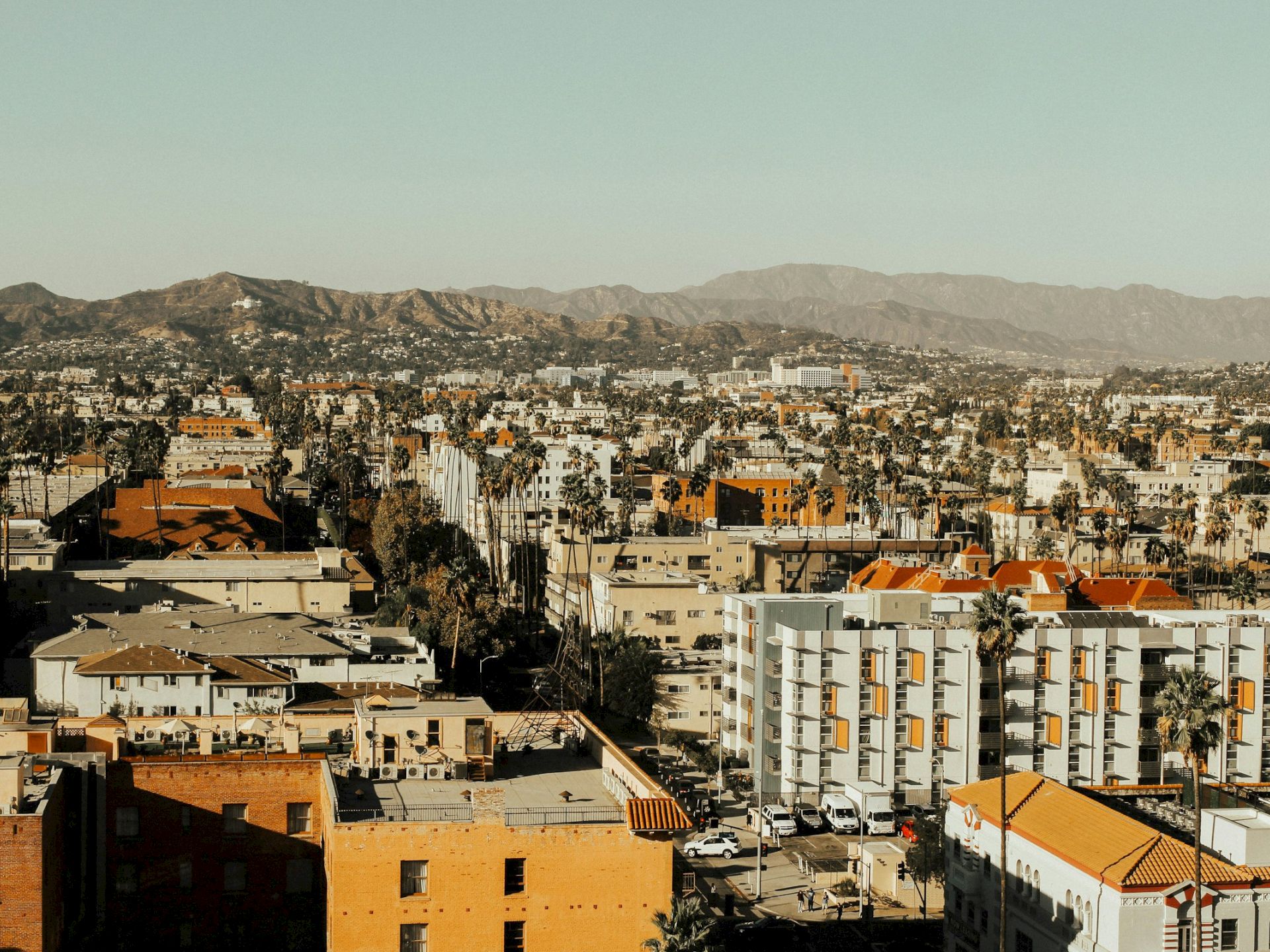 A cityscape with buildings and mountains in the background