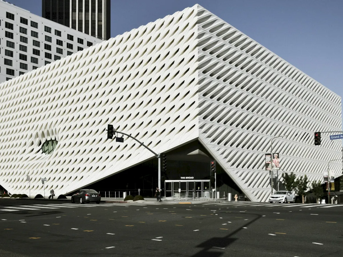 A large, modern, white building with a unique exterior design.