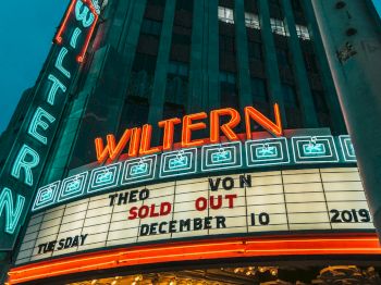 The image shows the neon marquee of The Wiltern theater, announcing a sold-out event for a performer on December 10, 2019.